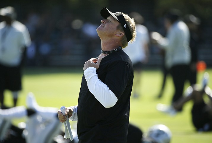 Oakland Raiders head coach Jon Gruden smiles watching his team stretch during NFL football practice in Napa, Calif., Friday, July 27, 2018. (Eric Risberg/AP)