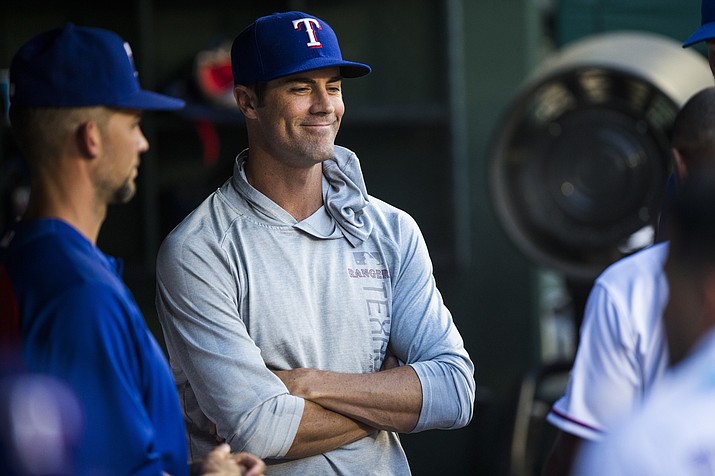 Texas Rangers pitcher Cole Hamels smiles as he talks to teammates in the dugout during the third inning of the team’s baseball game against the Oakland Athletics on Thursday, July 26, 2018, in Arlington, Texas. (Ashley Landis/The Dallas Morning News, via AP)