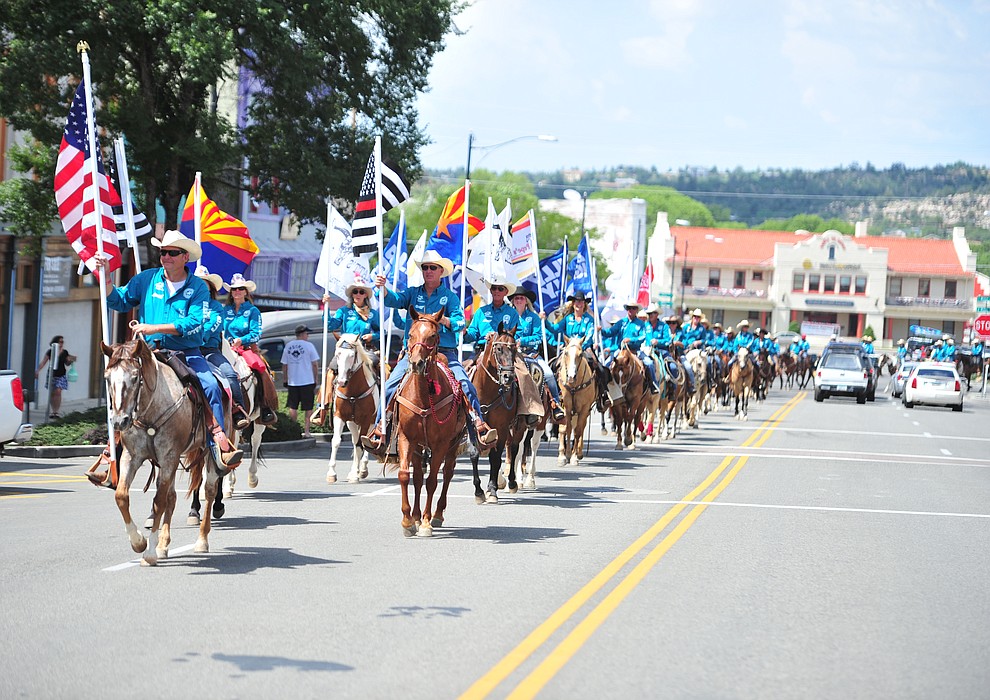 Almost 100 horseback riders ride along Cortez Street as part of the 13th annual Whiskey Row Shoout and National Day of the Cowboy in Prescott Saturday, July 28, 2018. (Les Stukenberg/Courier)
