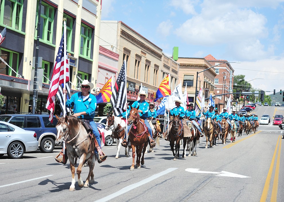 Almost 100 horseback riders ride along Gurley Street as part of the 13th annual Whiskey Row Shoout and National Day of the Cowboy in Prescott Saturday, July 28, 2018. (Les Stukenberg/Courier)