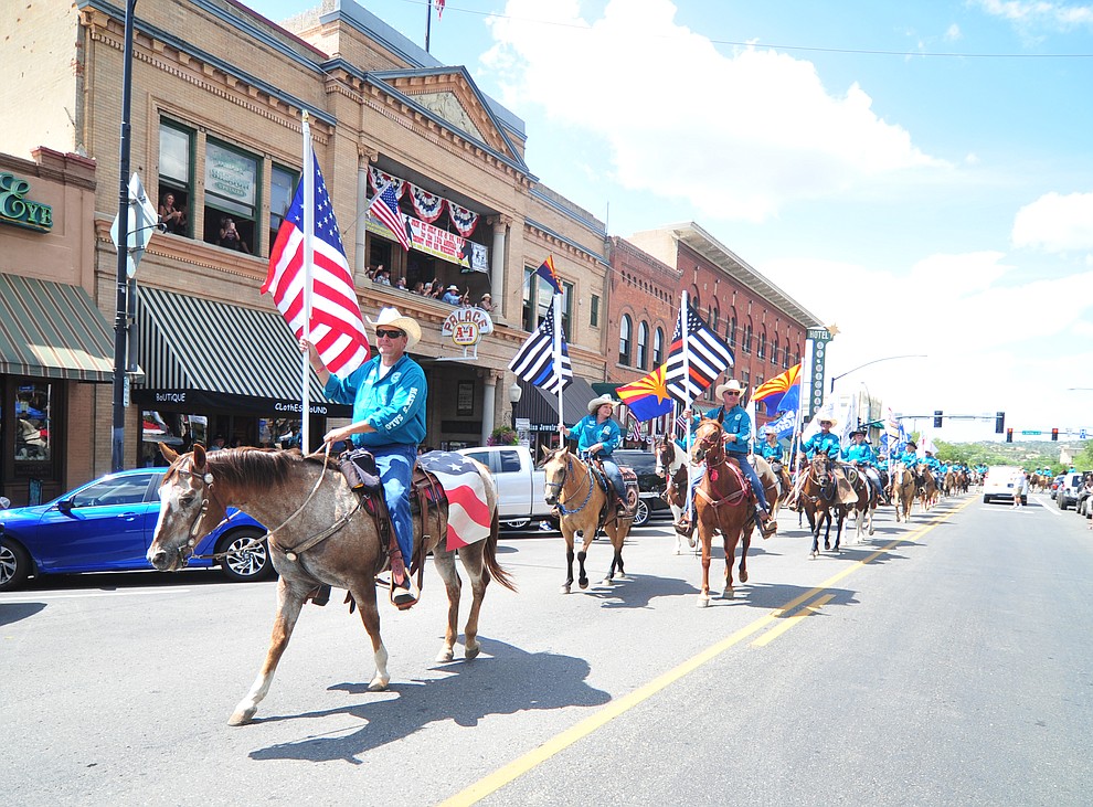 Almost 100 horseback riders ride along Motezuma Street as part of the 13th annual Whiskey Row Shoout and National Day of the Cowboy in Prescott Saturday, July 28, 2018. (Les Stukenberg/Courier)
