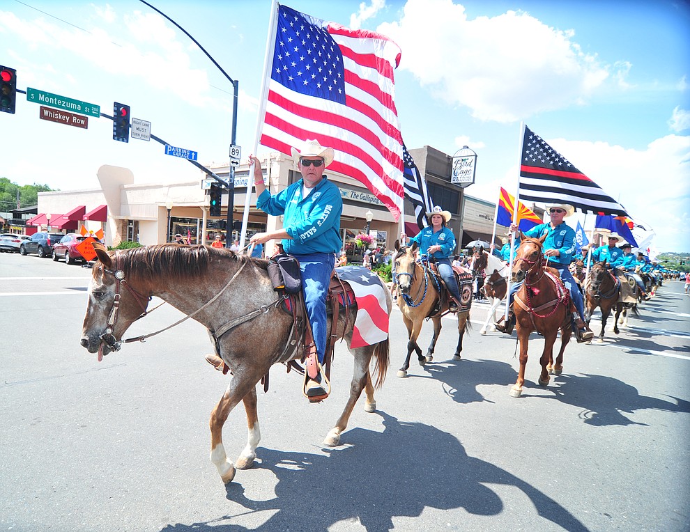 Almost 100 horseback riders ride along Motezuma Street as part of the 13th annual Whiskey Row Shoout and National Day of the Cowboy in Prescott Saturday, July 28, 2018. (Les Stukenberg/Courier)