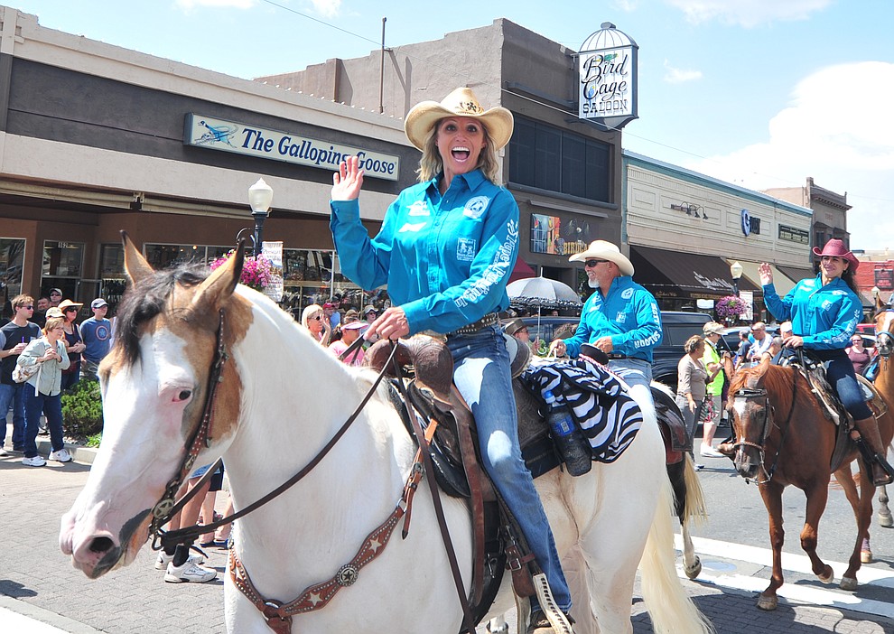 Kimberly Harmon and almost 100 horseback riders ride along Motezuma Street as part of the 13th annual Whiskey Row Shoout and National Day of the Cowboy in Prescott Saturday, July 28, 2018. (Les Stukenberg/Courier)