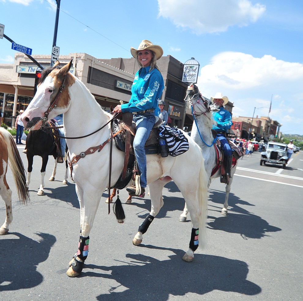 Kimberly Harmon and almost 100 horseback riders ride along Motezuma Street as part of the 13th annual Whiskey Row Shoout and National Day of the Cowboy in Prescott Saturday, July 28, 2018. (Les Stukenberg/Courier)