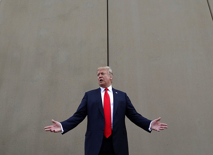 In this March 13, 2018, file photo, President Donald Trump speaks during a tour as he reviews border wall prototypes in San Diego. Trump said Sunday, July 29, 2018, that he would consider shutting down the government if Democrats refuse to vote for his immigration proposals, including building a wall along the U.S.-Mexico border. (AP Photo/Evan Vucci, File)

