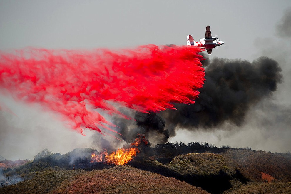An air tanker drops retardant on a wildfire burning near Lakeport, Calif., on Monday, July 30, 2018. A pair of wildfires that prompted evacuation orders for thousands of people are barreling toward small lake towns in Northern California. (AP Photo/Noah Berger)