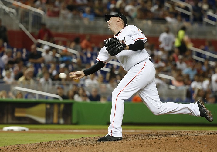In this July 26, 2018, file photo, Miami Marlins' Brad Ziegler delivers a pitch during the sixth inning of a baseball game against the Washington Nationals, in Miami. Right-handed reliever Brad Ziegler has been traded to the Arizona Diamondbacks, who bolstered their bullpen for the pennant race and gave up Double-A reliever Tommy Eveld to the Florida Marlins, Tuesday, July 31, 2018. (Wilfredo Lee/AP, file)