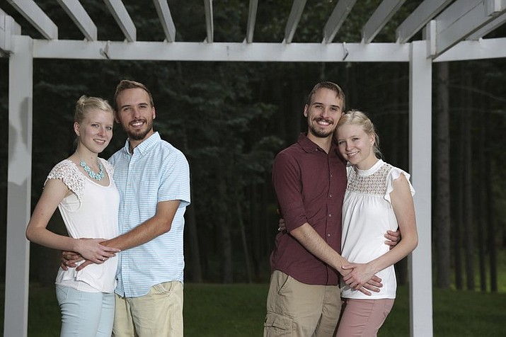 From left, Krissie Bevier and fianc, Zack Lewan and Nicholas Lewan and fianc, Kassie Bevier, pose for a photo, Sunday, July 29, 2018, in Grass Lake. Identical twins Krissie and Kassie Bevier are marrying identical twins, Zack and Nicholas Lewan. (Nikos Frazier /Jackson Citizen Patriot via AP)


