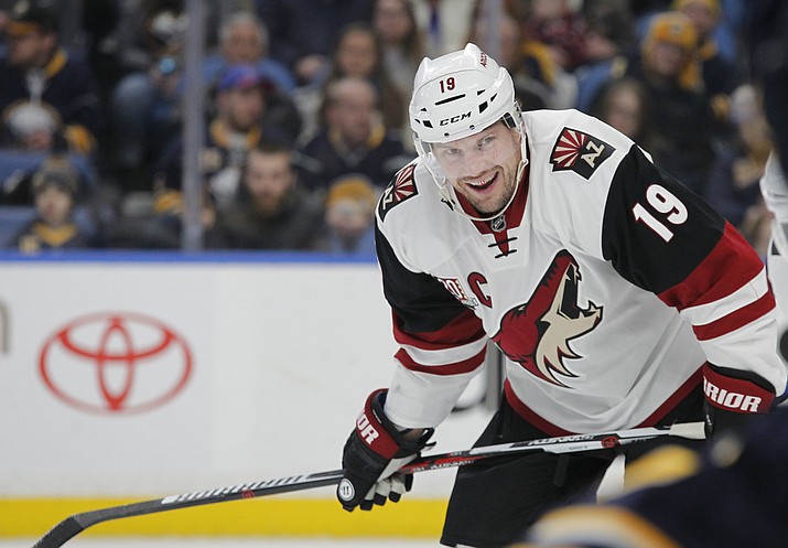 In this March 2, 2017, file photo, Arizona Coyotes forward Shane Doan (19) looks on during the first period of an NHL hockey game against the Buffalo Sabres in Buffalo, N.Y. The Coyotes will retire Doan’s No. 19 during a pregame ceremony on Feb. 24, 2019, when they face the Winnipeg Jets. Doan spent his entire 21-year career with the Coyotes before retiring prior to the 2017-18 season. (Jeffrey T. Barnes/AP, file)