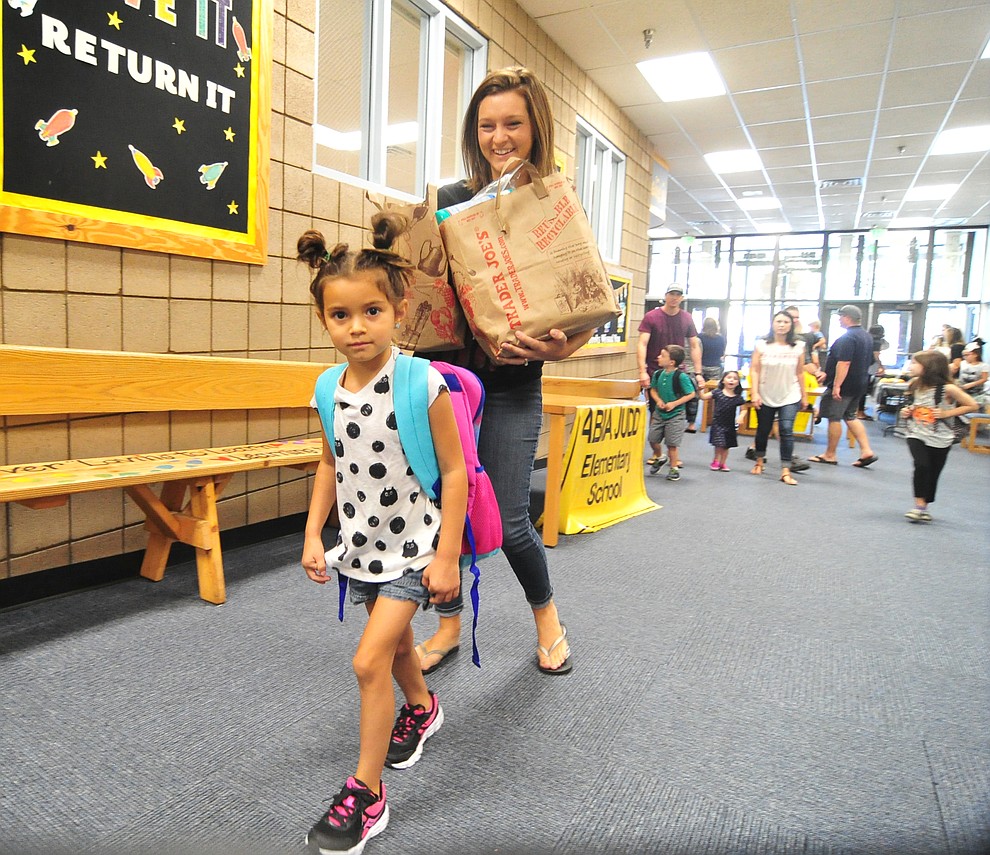 Kindergartener Rilyn Lucero walks in with Stephanie, with an armful of supplies, at Abia Judd Elementary School Thursday, August 2, 2018 as Prescott Unified School District starts the 2018-19 school year. (Les Stukenberg/Courier)