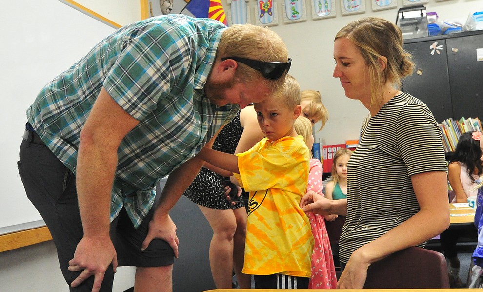 Clayton Donaldson isn't quite sure he wants to have Kelly Donaldson and Lucy Taylor to leave his kindergarten classroom at Abia Judd Elementary School Thursday, August 2, 2018 as Prescott Unified School District starts the 2018-19 school year. (Les Stukenberg/Courier)