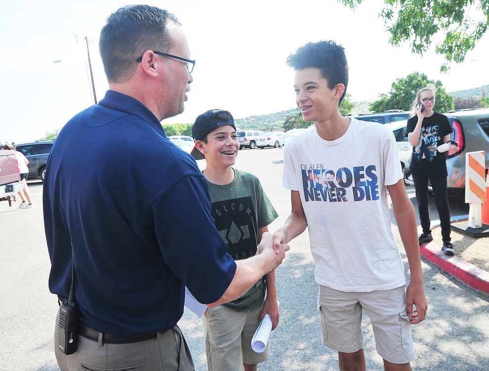 Principal Mark Goligoski greets Frank Castro and Jonas Carmen during freshman orientation at Prescott High School Tuesday, July 31, 2018. (Les Stukenberg/Courier)