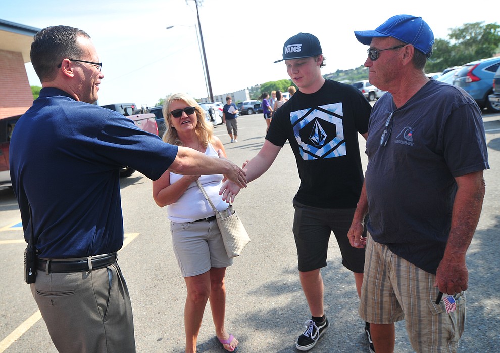 Principal Mark Goligoski greets Jacob Uren and his grandparents Pam and Tom Shipley during freshman orientation at Prescott High School Tuesday, July 31, 2018. (Les Stukenberg/Courier)