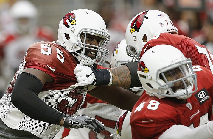 Arizona Cardinals defensive end Chandler Jones (55) tries to break away from offensive guard Mike Iupati, back right, as running back Derrick Coleman (48) makes a block during an NFL football practice Saturday, Aug. 4, 2018, in Glendale. (Ross D. Franklin/AP, file)