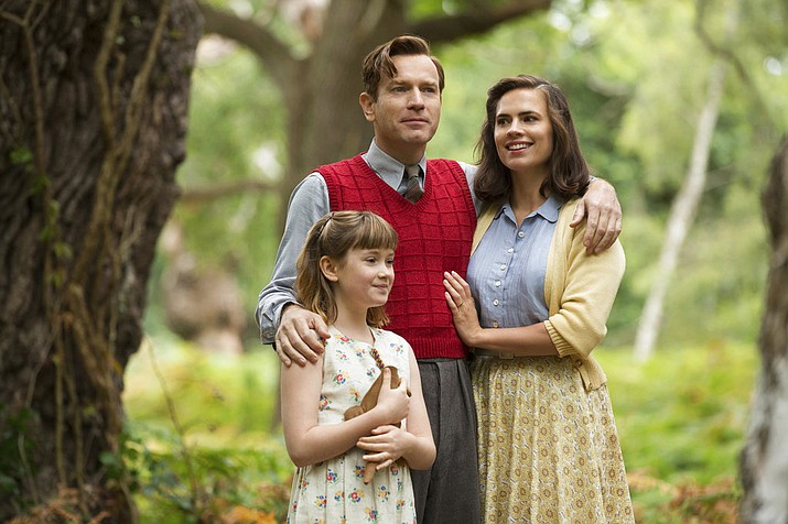 This image released by Disney shows, from left, Bronte Carmichael, Ewan McGregor and Hayley Atwell in a scene from "Christopher Robin." (Laurie Sparham/Disney via AP)

