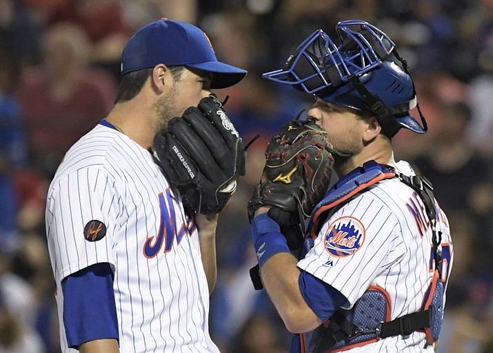 New York Mets relief pitcher Anthony Swarzak, left, talks with catcher Devin Mesoraco during the ninth inning of the team’s baseball game against the Atlanta Braves on Friday, Aug. 3, 2018 in New York.the Braves won 2-1. (AP Photo/Bill Kostroun)

