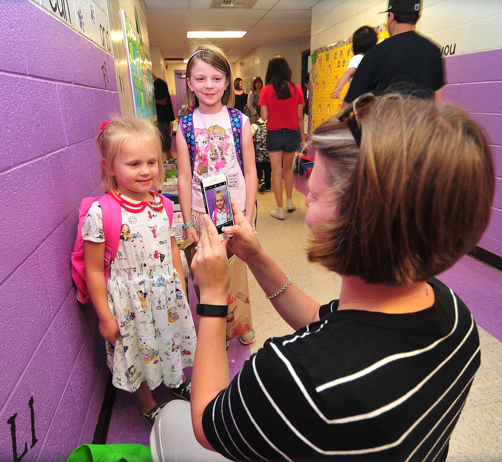 Beth Parknowitz gets photos of her daughters Kasey and Emma during the first day of school at Coyote Springs Elementary in Prescott Valley Monday, August 6, 2018. (Les Stukenberg/Courier)