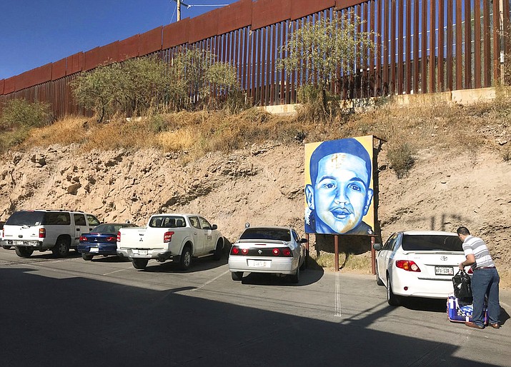 A portrait of 16-year-old Mexican youth Jose Antonio Elena Rodriguez, who was shot and killed in Nogales, Sonora, Mexico, is displayed Dec. 4, 2017, on the Nogales street where he was killed that runs parallel with the U.S. border. Closing arguments are expected in Tucson, Ariz., this week in the trial of U.S. Border Patrol agent Lonnie Swartz, charged in the 2012 fatal shooting 16-year-old Jose Antonio Elena Rodriguez across the Mexican border. (Anita Snow/AP Photo, file)