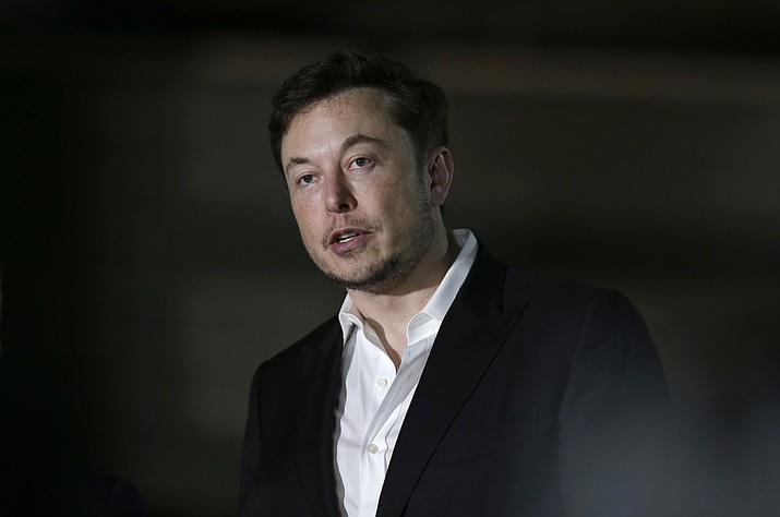 FILE- In this June 14, 2018, file photo Tesla CEO and founder of the Boring Company Elon Musk speaks at a news conference in Chicago. Musk says he is considering taking the electric car maker private. Tesla’s stock spiked Tuesday, Aug. 7, after Musk made the abrupt announcement in a terse tweet. (Kiichiro Sato/AP Photo, file)