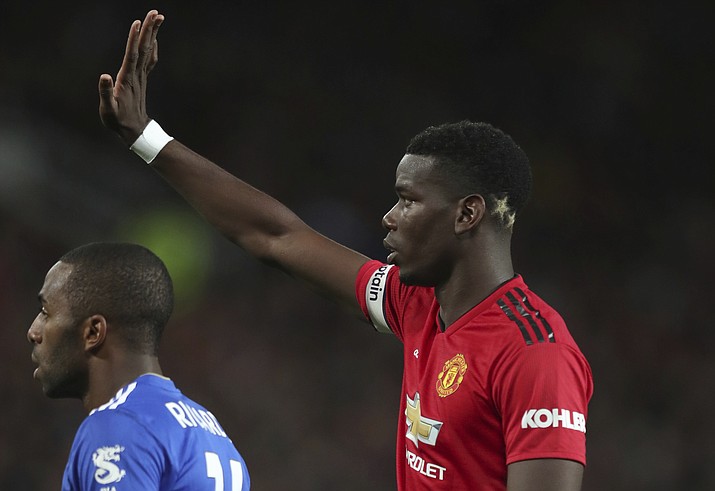 Manchester United's Paul Pogba, gestures to a teammates and who has two gold stars colouring the back of his head, a reference to the 2 World Cups that France have won, the during the English Premier League soccer match between Manchester United and Leicester City at Old Trafford, in Manchester, England, Friday, Aug. 10, 2018. (Jon Super/AP)