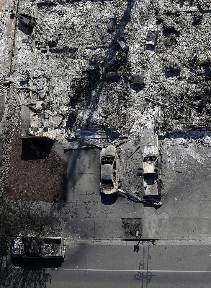 In this Oct. 14, 2017, file photo, an aerial view shows the devastation of the Coffey Park neighborhood after a wildfire swept through the area in Santa Rosa, Calif. Tariffs on imported construction materials are making it more expensive to rebuild homes lost to wildfires and other natural disasters. (Marcio Jose Sanchez/AP, File)