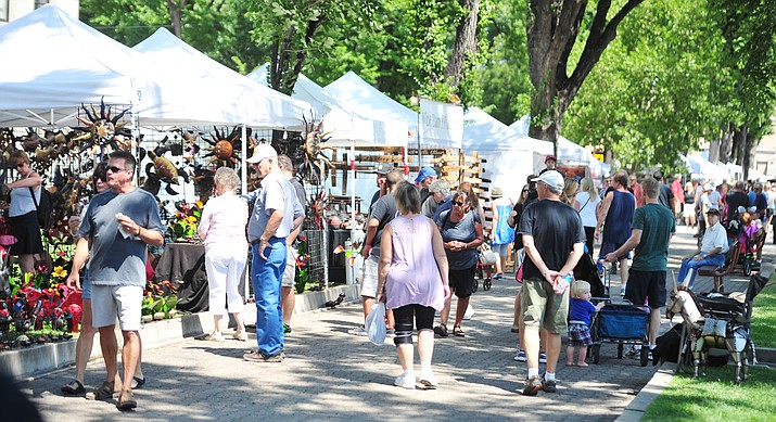 Large crowds visit the booths at the Mountain Artists Guild’s 68th annual August Arts & Crafts Festival Saturday, Aug. 11, 2018, on the courthouse plaza in Prescott. The show continues Sunday, Aug. 12. (Les Stukenberg/Courier)