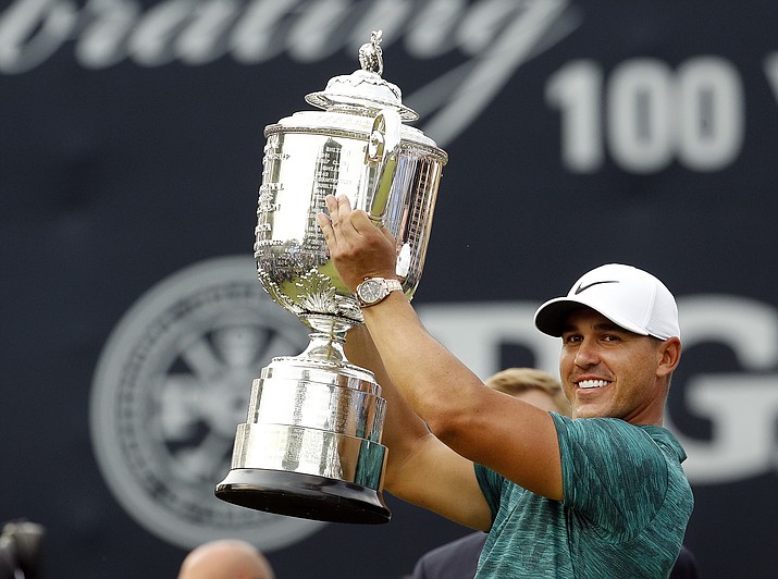Brooks Koepka lifts the Wanamaker Trophy after winning the PGA Championship golf tournament at Bellerive Country Club, Sunday, Aug. 12, 2018, in St. Louis. (Charlie Riedel/AP Photo)