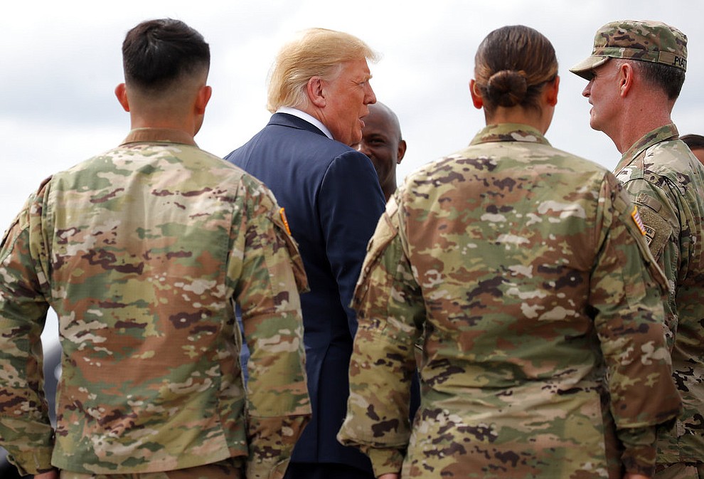 President Donald Trump greets member of the military as he arrives on Air Force One at Wheeler-Sack Army Air Field in Fort Drum, N.Y., Monday, Aug. 13, 2018. (AP Photo/Carolyn Kaster)
