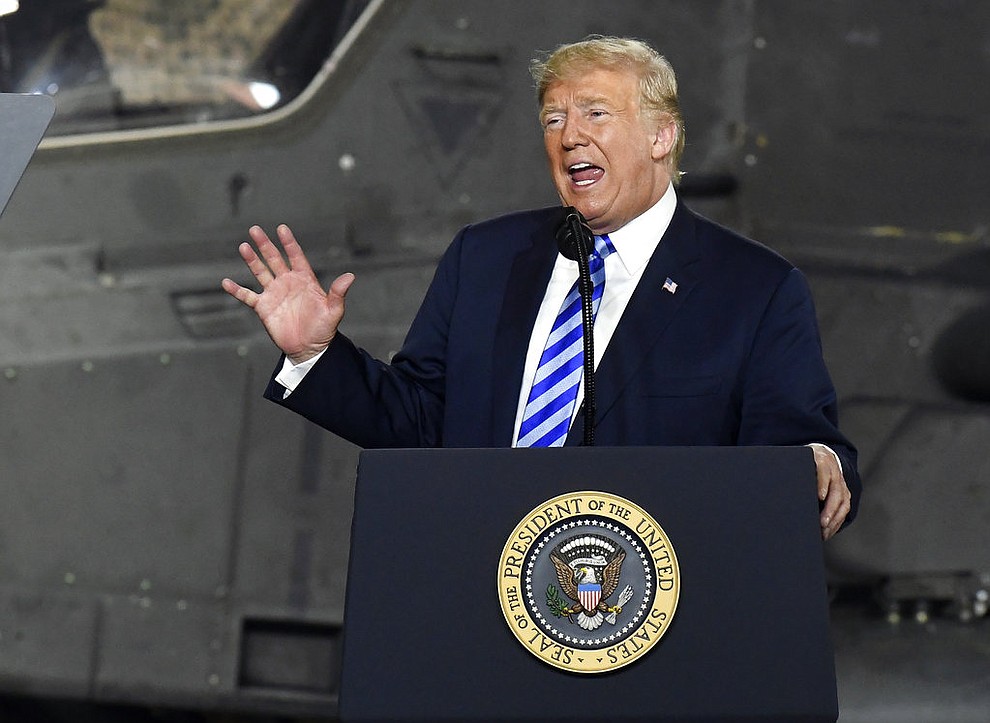 President Donald Trump speaks before signing the $716 billion defense policy bill named for Sen. John McCain during a ceremony Monday, Aug. 13, 2018, in Fort Drum, N.Y.  (AP Photo/Hans Pennink)