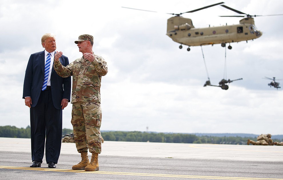 President Donald Trump and Maj. Gen. Walter Piatt view air assault exercise at Fort Drum, N.Y., Monday, Aug. 13, 2018, before a signing ceremony for a $716 billion defense policy bill named for Sen. John McCain. (AP Photo/Carolyn Kaster)