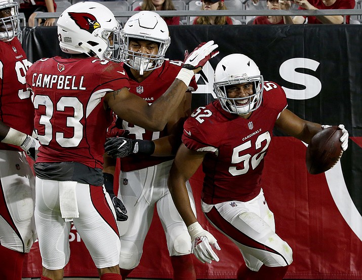 Arizona Cardinals linebacker Jeremy Cash (52) celebrates his fumble recovery for a touchdown against the Los Angeles Chargers with defensive back Chris Campbell (33) and defensive back Ezekiel Turner (47) during the second half of a preseason NFL football game, Saturday, Aug. 11, 2018, in Glendale. (Ross D. Franklin/AP Photo)