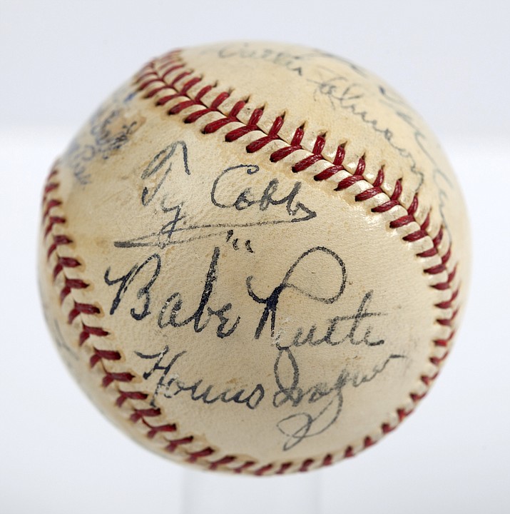 In this undated photo provided by SCP Auctions is a baseball with the signatures of Babe Ruth, Ty Cobb, Honus Wagner and eight other legends of the game that has sold for more than $600,000. The players all signed the ball on the same day in 1939, when they had gathered to become the first class to enter the Baseball Hall of Fame. SCP Auctions said Monday, Aug. 13, 2018, that it has sold for just over $623,000. That crushes the previous record of $345,000 for a signed ball, set in 2013. (SCP Auctions via AP)