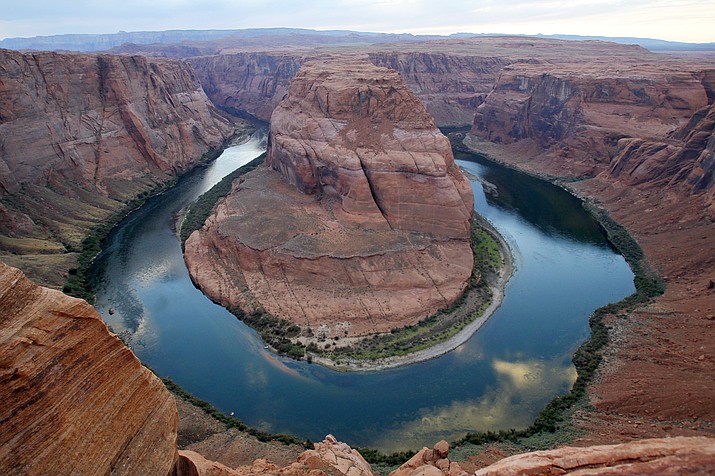 This Sept. 9, 2011 photo shows the dramatic bend in the Colorado River at a the popular Horseshoe Bend in Glen Canyon National Recreation Area, in Page, Ariz. The spot is so popular that authorities have imposed parking restrictions for safety, and a new viewing deck has also been built recently. (Ross D. Franklin/AP)

