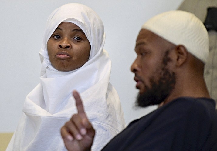 Defendants Hujrah Wahhaj, left, and Siraj Wahhaj talk during a break in court hearings, Monday, Aug. 13, 2018, in Taos, N.M. The Wahhajs were among several people arrested after authorities raided a property and found 11 children living on a squalid compound on the outskirts of tiny Amalia, N.M., a week earlier. (Roberto E. Rosales/The Albuquerque Journal via AP, Pool)