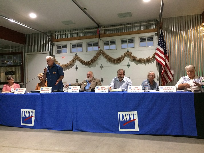 Dewey-Humboldt council member Doug Treadway, running for one of three council seats, answers a question at the Candidate Forum Aug. 9 at the Cherry Ranch Event Center in Dewey. From left are Nancy Wright (council), Victoria Wendt (mayor), Treadway, Terry Nolan (mayor), Mark McBrady (council), Lynn Collins (council), and Karen Brooks (council). (Sue Tone/Tribune)