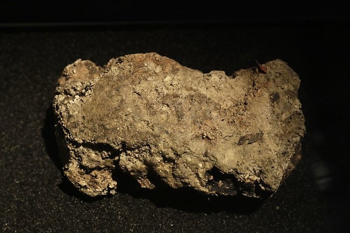 In this Thursday, Feb. 8, 2018 file photo, the only remaining piece of the 130 ton, 250 meter long fatberg, removed from the sewers in the Whitechapel area of east London in the latter months of 2017, is displayed during a media preview at the Museum of London in London. London’s famous, festering fatberg lives on - and is getting its own livestream. The Museum of London said on Tuesday, Aug. 14 a chunk of oil, fat, diapers and baby wipes blasted out of a city sewer last year is now part of its permanent collection. The museum says the “highly toxic” lump will be stored in a secure case and displayed online via a “fatcam” so that viewers can watch its changes. (AP Photo/Matt Dunham, file)

