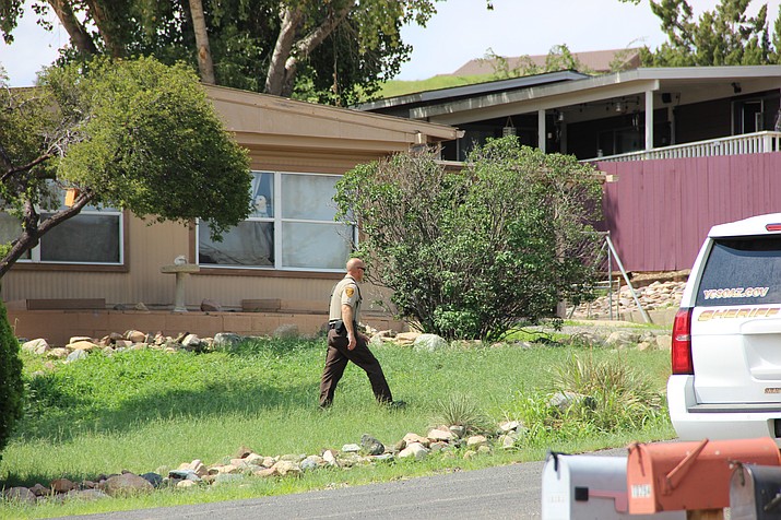 A deputy with the Yavapai County Sheriff’s Office patrols the perimeter of a home located in the Prescott Country Club community in Dewey Wednesday afternoon, Aug. 15. The home's occupant was not responding to police requests to speak with him at the time after he allegedly left the scene of a vehicle accident in Prescott Valley. 