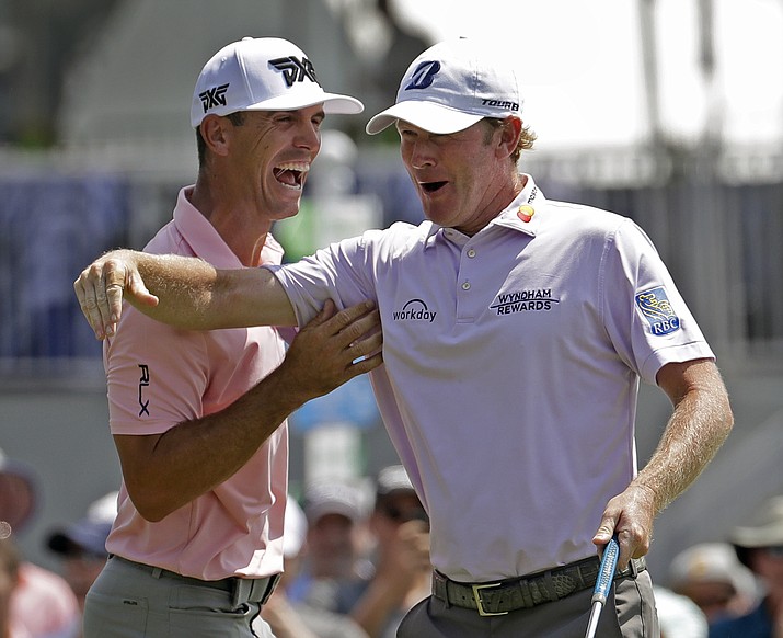 Brandt Snedeker, right, celebrates with playing partner Billy Horschel, left, after making a birdie putt on the ninth hole during the first round of the Wyndham Championship golf tournament in Greensboro, N.C., Thursday, Aug. 16, 2018. Sneaker shot a 59 in the first round. (Chuck Burton/AP)