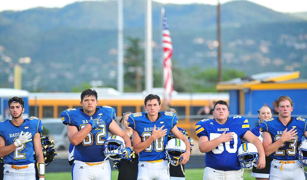 Prescott's AFJROTC students raise the flag before the Badgers take on Desert Edge Friday August 17, 2018 to open the 2018 football season. (Les Stukenberg/Courier)