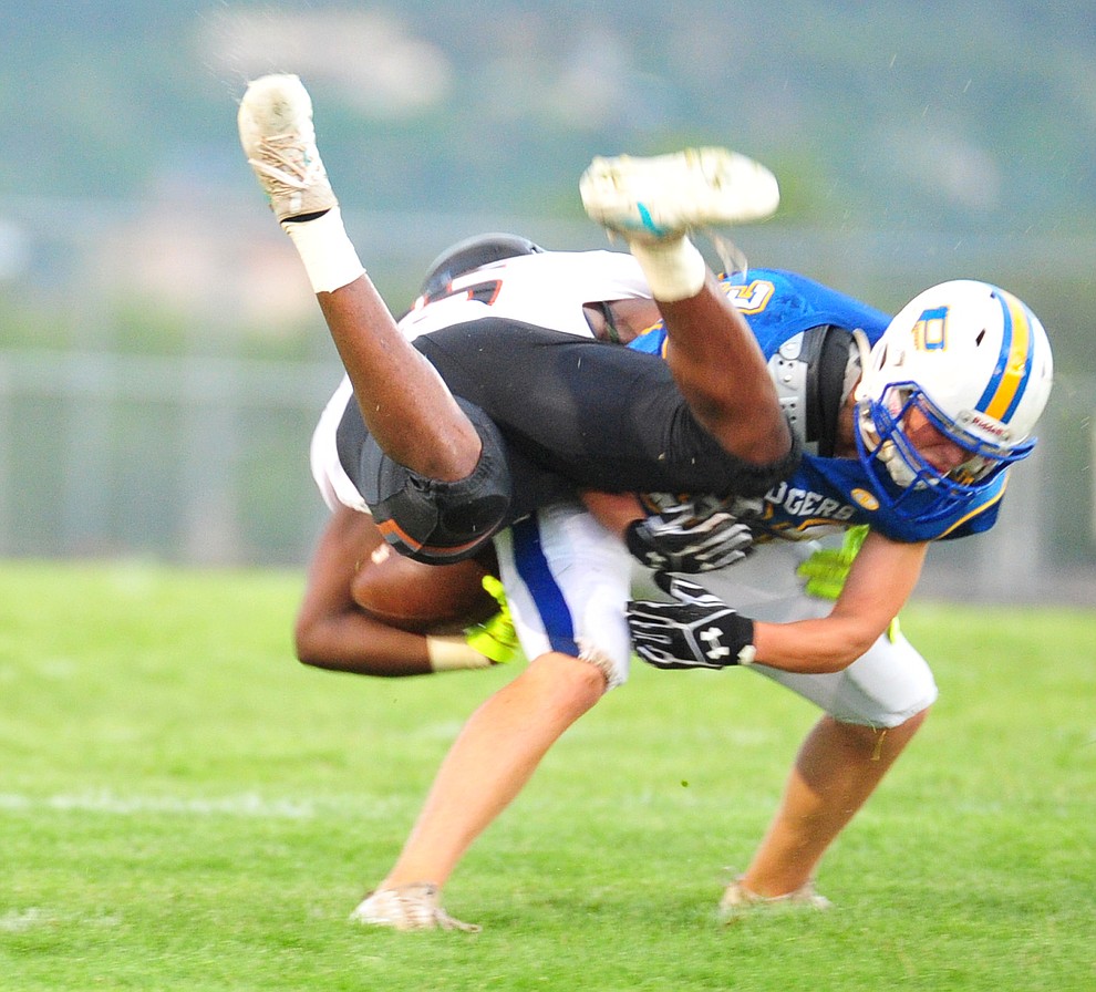 Prescott's Rhett Pearce makes a tackle as the Badgers take on Desert Edge Friday August 17, 2018 to open the 2018 football season. (Les Stukenberg/Courier)