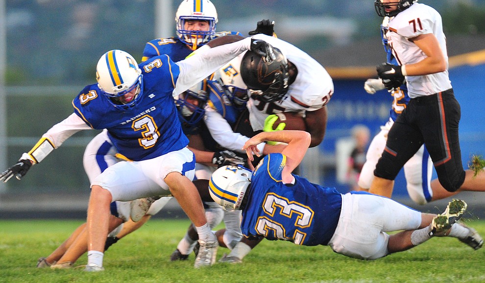 Prescott's defenders make a tackle as the Badgers take on Desert Edge Friday August 17, 2018 to open the 2018 football season. (Les Stukenberg/Courier)