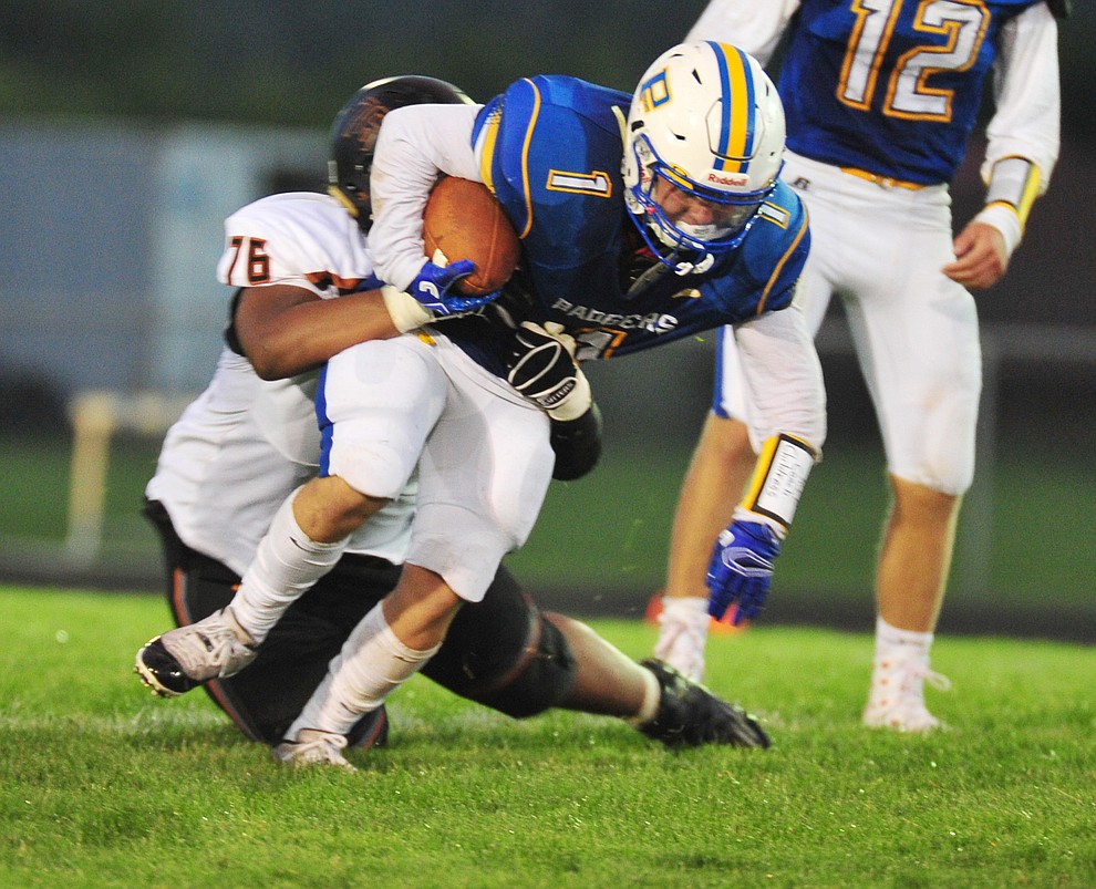 Prescott's Sylas Espitia tries to break a tackle as the Badgers take on Desert Edge Friday August 17, 2018 to open the 2018 football season. (Les Stukenberg/Courier)