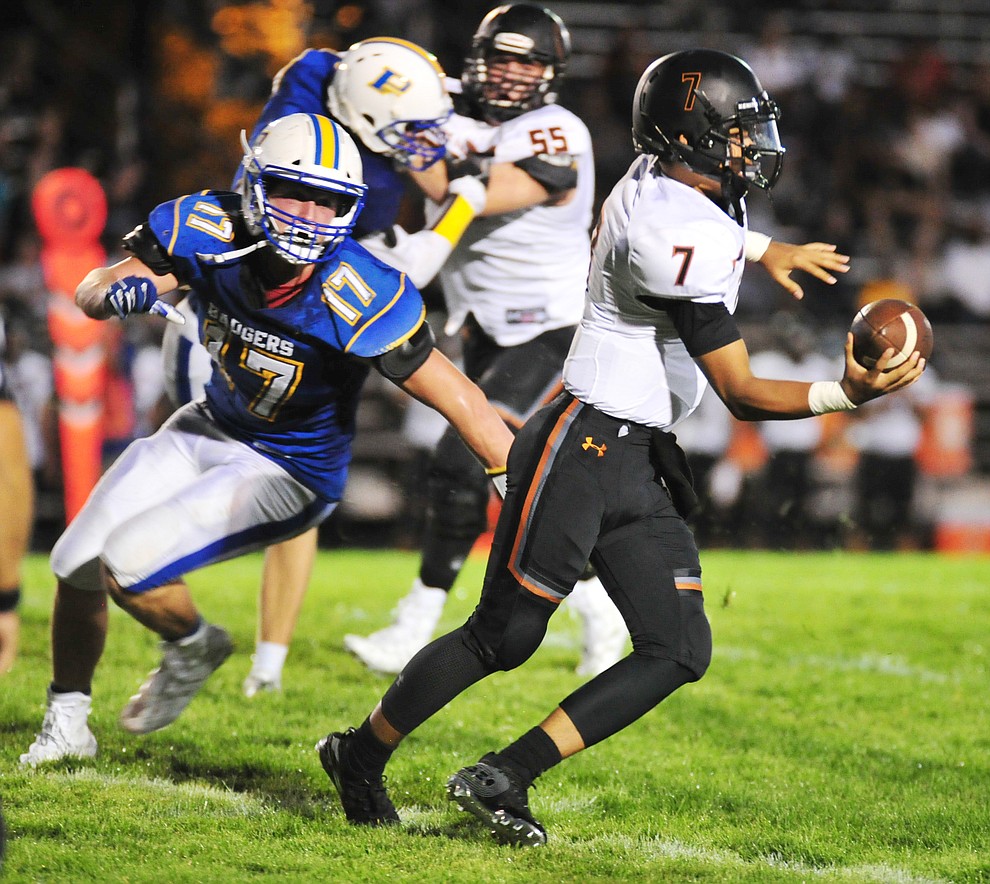 Prescott's Aaron Greene puts pressure on the quarterback as the Badgers take on Desert Edge Friday August 17, 2018 to open the 2018 football season. (Les Stukenberg/Courier)