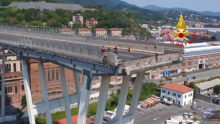 In this frame taken from a video released by the Vigili del Fuoco (Firefighters), an aerial view of the collapsed Morandi highway bridge, in Genoa, Saturday, Aug. 18, 2018. Saturday has been declared a national day of mourning in Italy and includes a state funeral at the industrial port city's fair grounds for those who plunged to their deaths as the 45-meter (150-foot) tall Morandi Bridge gave way Tuesday. (Vigil del Fuoco via AP)

