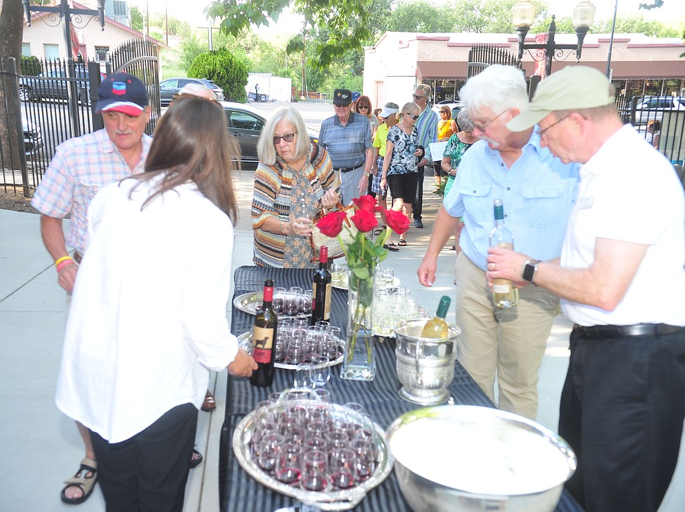 Patrons enter to a choice of red or white wine at the 6th annual Sharlot's WInefest at the Sharlot Hall Museum in Prescott Saturday, August 18, 2018. (Les Stukenberg/Courier)