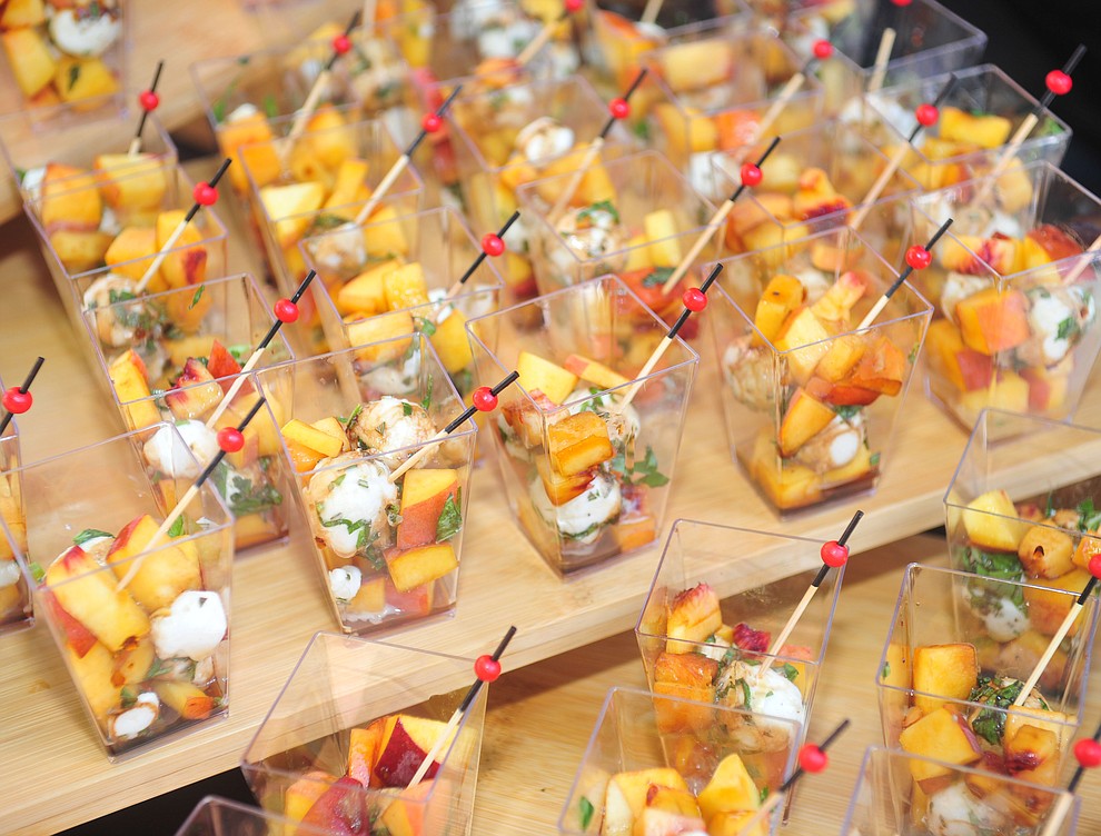 El Gato Azul served up a Fall Caprece of fresh peaches, mozerella, rosemary, basil with a maple balsemic at the 6th annual Sharlot's WInefest at the Sharlot Hall Museum in Prescott Saturday, August 18, 2018. (Les Stukenberg/Courier)