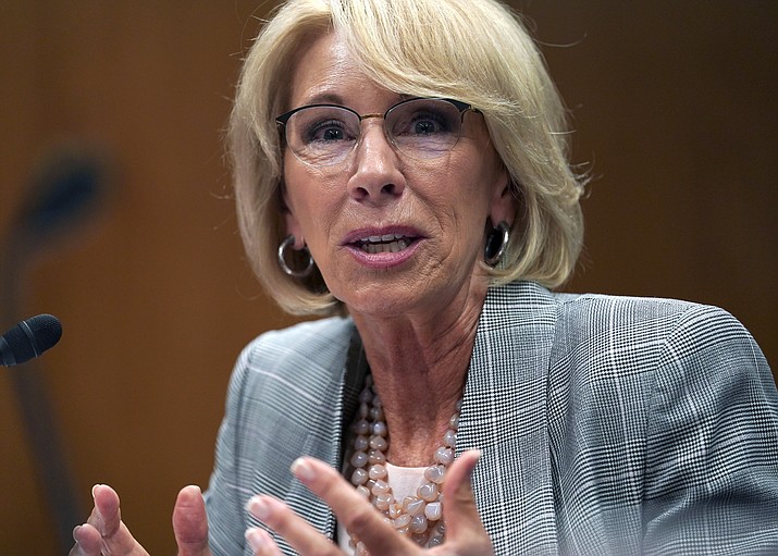 In this June 5, 2018, file photo, Education Secretary Betsy DeVos testifies during hearing on the FY19 budget on Capitol Hill in Washington. Support for charter schools and private school voucher programs has gone up over the past year, with Republicans accounting for much of the increase, according to a survey published Tuesday, Aug. 21. The findings by Education Next, a journal published by Harvard's Kennedy School and Stanford University, come as DeVos promotes alternatives to traditional public schools.(AP Photo/Carolyn Kaster/AP, file)