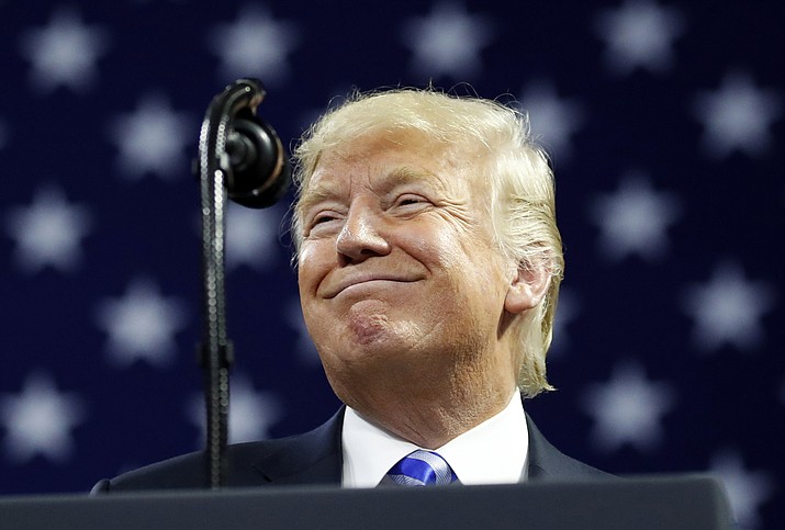 In this Aug. 21, 2018 photo, President Donald Trump pauses while speaking during a in Charleston, W.Va.  Trump assailed longtime personal attorney Michael Cohen for making a plea deal in an interview that aired Thursday, accusing his former fixer of “flipping” and arguing “it almost ought to be illegal.”  (AP Photo/Alex Brandon)