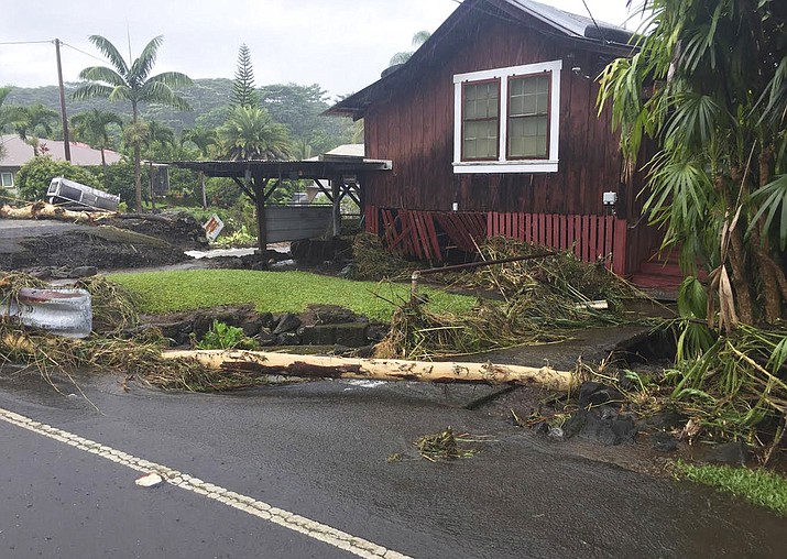 This photo provided by Jessica Henricks shows damage from Hurricane Lane Friday, Aug. 24, 2018, near Hilo, Hawaii. Hurricane Lane barreled toward Hawaii on Friday, dumping torrential rains that inundated the Big Island's main city as people elsewhere stocked up on supplies and piled sandbags to shield oceanfront businesses against the increasingly violent surf. The city of Hilo, population 43,000, was flooded with waist-high water. (Jessica Henricks via AP)

