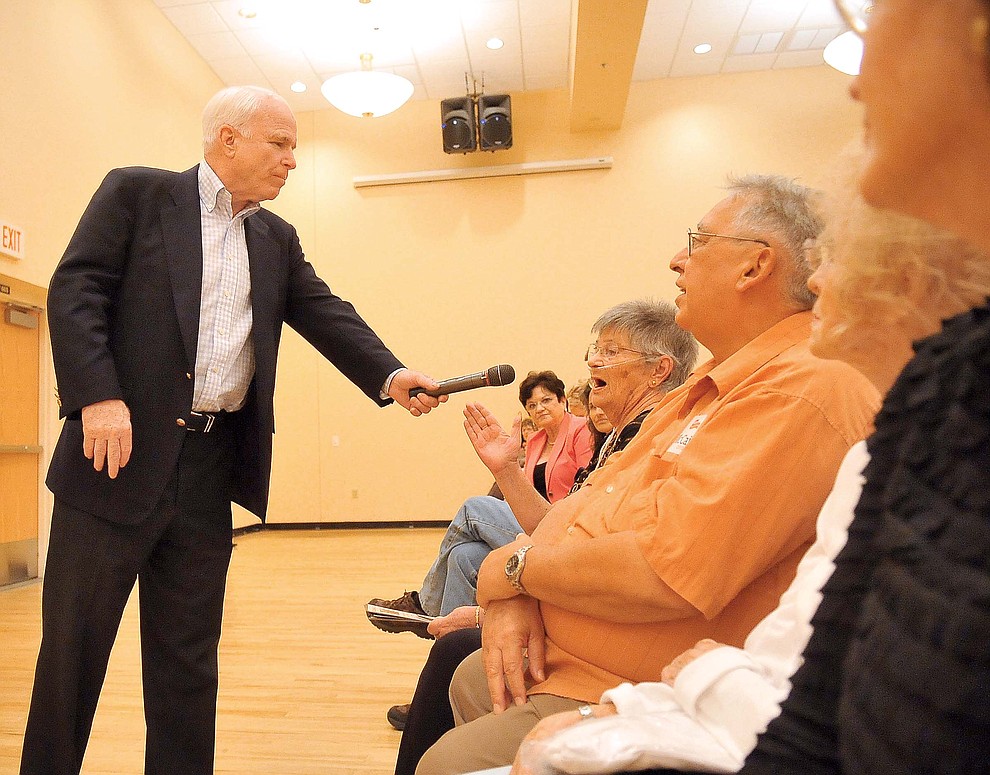 Prescott 07-24-10.Matt Hinshaw/The Daily Courier.U.S. Senator, R-Arizona, John McCain holds the microphone for Nancy Warren of Prescott while she asks him a question during a town hall style meeting at the Adult Center of Prescott Saturday afternoon.
